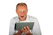 Surprised man with his tablet computer