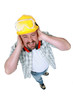Landscape picture of worker covering his ears