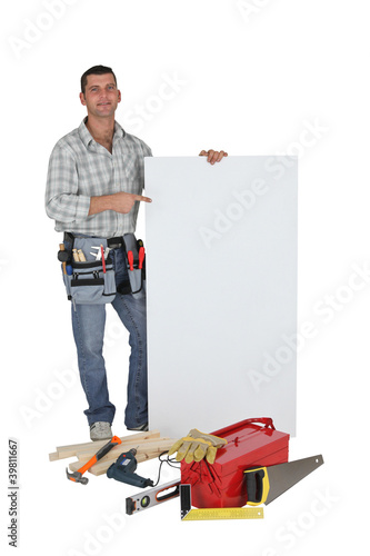 Photo: Carpenter stood with blank advertising panel Carpenter stood with blank advertising panel