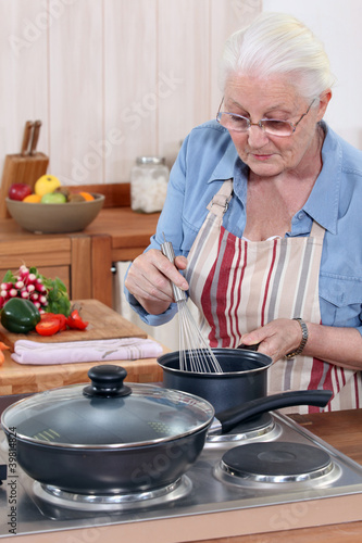 Photo: Senior woman cooking Senior woman cooking