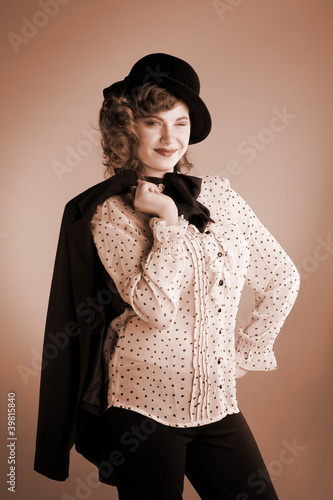 Photo: The girl in a white shirt and a hat poses The girl in a white shirt and a hat poses