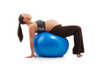Photo: Pregnant woman doing exercises with gim ball, isolated on white Pregnant woman doing exercises with gim ball, isolated on white