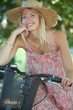 Woman with hat on a bicycle