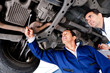Mechanics fixing a car