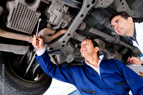 Photo: Mechanics fixing a car Mechanics fixing a car