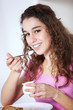 Young woman eating yogurt