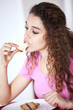 Young woman eating toast