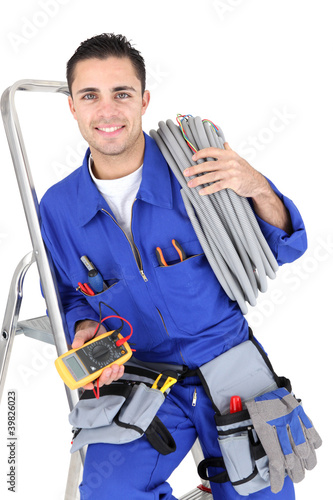 Photo: Electrician with a voltmeter and cable Electrician with a voltmeter and cable