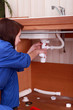 Female plumber repairing sink