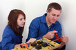Man teaching apprentice how to cut tube