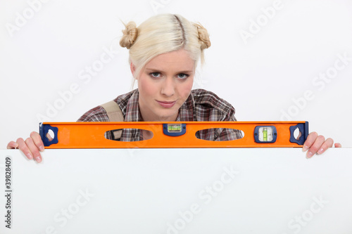 Photo: Woman with a spirit level Woman with a spirit level