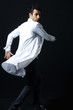 Photo: Hip-hop style dancer posing on a black background Hip-hop style dancer posing on a black background