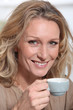 mature blonde woman  with a cup of coffee