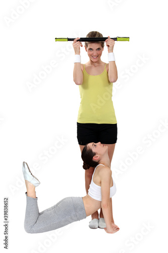 Photo: two girlfriends training together in the gym two girlfriends training together in the gym