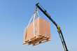 Crane elevating a box Crane elevating a box