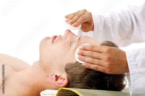 Photo: man getting a massage facial from therapist man getting a massage facial from therapist