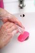 Woman wash soapy hands in bathroom