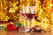 christmass dinner with rose candies and two glasses of red wine