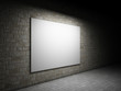 Blank billboard on a brick wall at night.