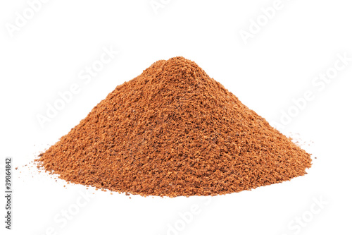 Photo: Heap of ground Cinnamon isolated on white background. Heap of ground Cinnamon isolated on white background.
