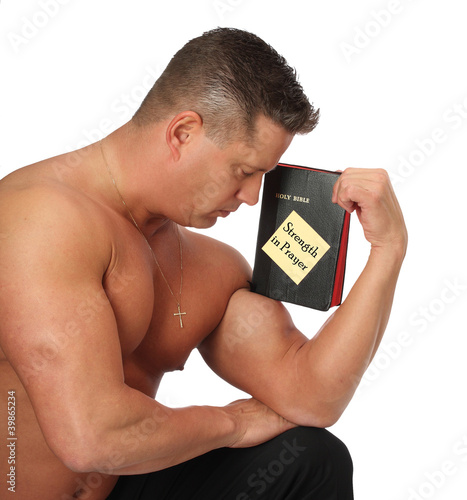Photo: Muscle Man with Bible in Prayer Muscle Man with Bible in Prayer