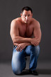 Photo: Adult muscular man, on the grey background Adult muscular man, on the grey background