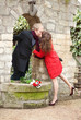 Dating couple kissing near the beautiful wall
