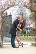 Dating couple hugging under beautiful arch