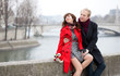 Dating couple at the Parisian embankment at misty day