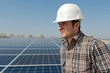 Worker in front of a photovoltaic plant Worker in front of a photovoltaic plant