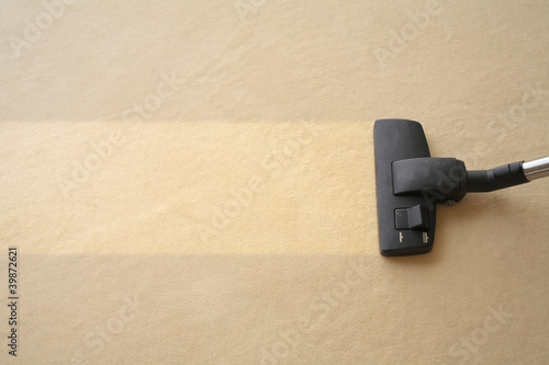 Photo: Vacuum Cleaner cleans carpet Vacuum Cleaner cleans carpet