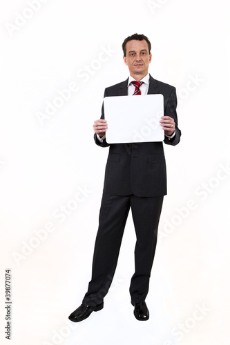 Foto: Business man with sign or board Business man with sign or board