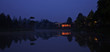 Light in house near lake in the morning