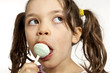 Close-up of little girl with a lollipop