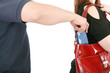 man pickpocketing a purse from woman