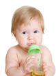adorable child drinking from bottle. 6 months old girl.