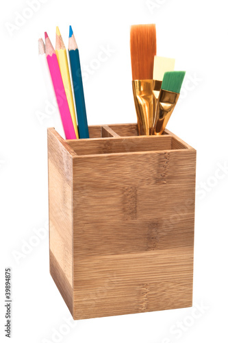 Photo: Pencils in wooden holder isolated on white Pencils in wooden holder isolated on white