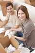 Happy Couple Unpacking or Packing Boxes Moving House