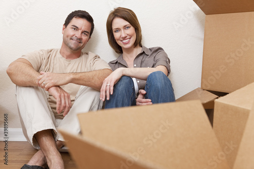 Photo: Happy Couple Unpacking or Packing Boxes Moving House Happy Couple Unpacking or Packing Boxes Moving House