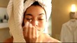 Mixed race woman applying eyeliner to her eyes