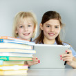 Twogirlfriends learn together with books and touchpad