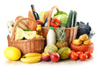 Groceries in wicker basket isolated on white Groceries in wicker basket isolated on white