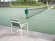 Chair and a tennis court Chair and a tennis court