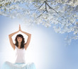 A young brunette woman meditating on a flower background A young brunette woman meditating on a flower background