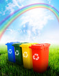 Photo: Colorful recycle bins with landscape background Colorful recycle bins with landscape background