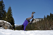 Young woman doing a cartwheel in the snow
