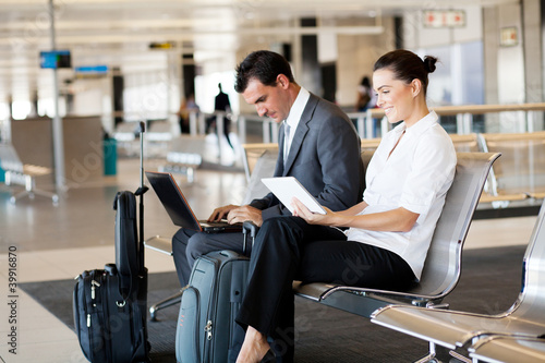 Photo: business travellers waiting for their flight at airport business travellers waiting for their flight at airport