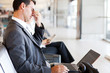 tired businessman taking a break at airport