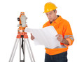 Senior land surveyor with theodolite