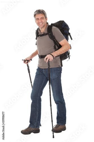 Foto: Senior man with backpack and hiking poles Senior man with backpack and hiking poles